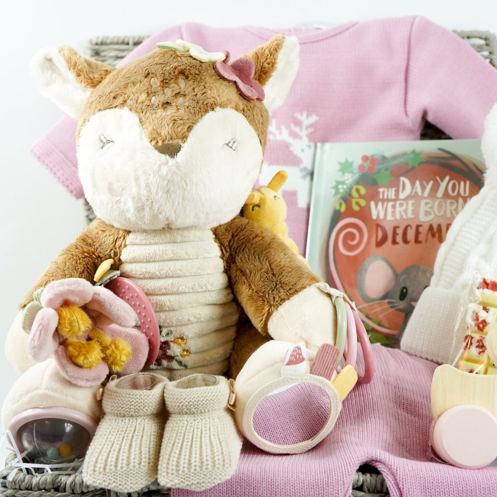 baby girl christmas hamper, Little Dutch soft activity deer, December baby book, baby pink knit Christmas outfit with white reindeer, wooden push along duck, Eaton mess chocolate bar, knit pom pom hat