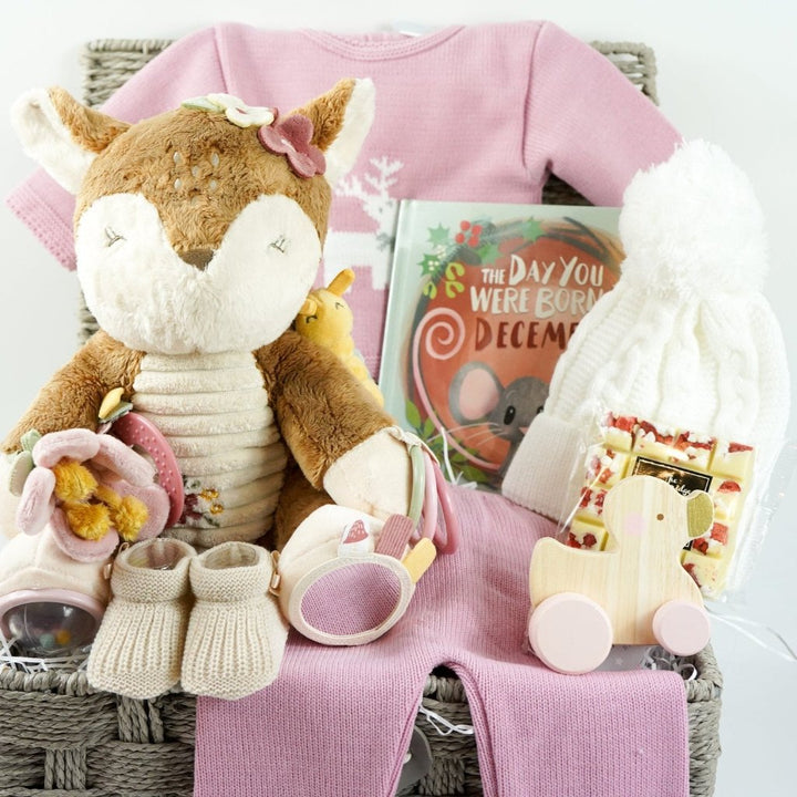 baby girl christmas hamper, Little Dutch soft activity deer, December baby book, baby pink knit Christmas outfit with white reindeer, wooden push along duck, Eaton mess chocolate bar, knit pom pom hat