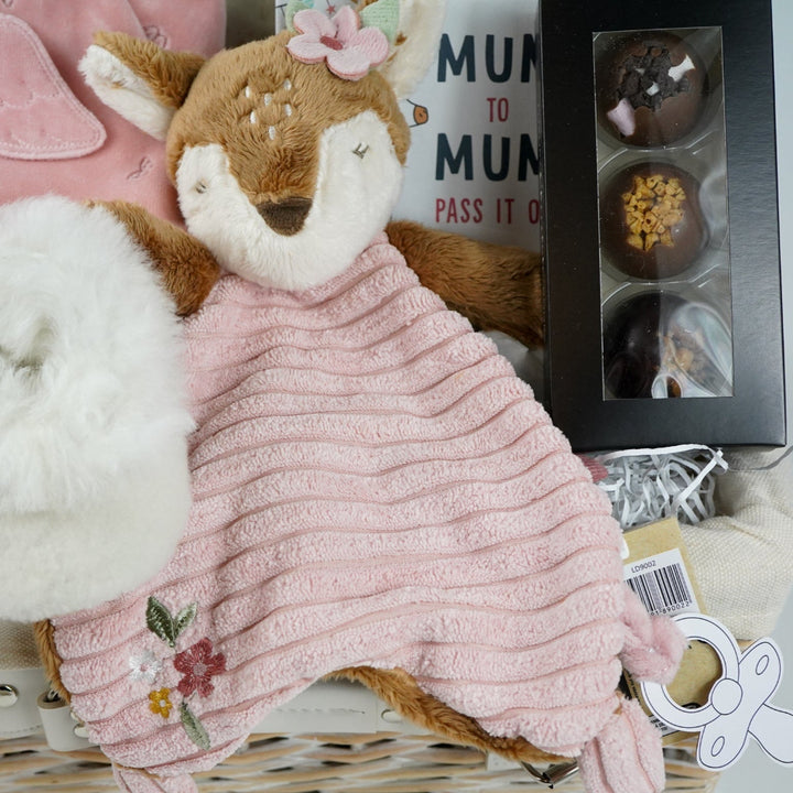 uxury mum and baby hamper, luxury pink velour sleepsuit with gold angel wings embroidery, pink star knit blanket, soft pink deer comforter,  ivory alpaca baby slippers, 4 sophie la giraffe muslins, box of chocolate domes, mum to mum tips book