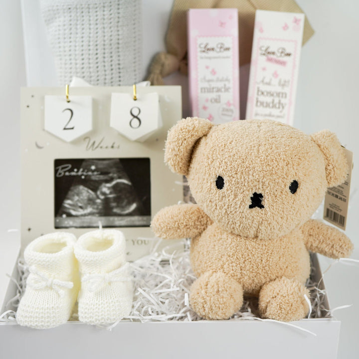 pregnancy hamper box, grey cellular baby blanket, biscuit coloured knot baby hat, antenatal toiletries, soft miffy teddy in biscuit, white knit booties, scan picture frame with pregnancy wooden countdown discs