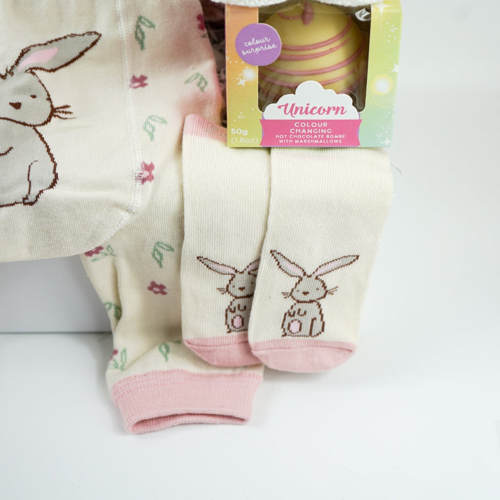 pink bunny baby hamper, pink hooded towel with bunny ears, soft bunny rabbit, bunny muslin, pink knit baby girl leggings with bunny on the  bum and matching socks with bunny, maracas in pin and grey with bunny face, white booties, , white chocolate bomb