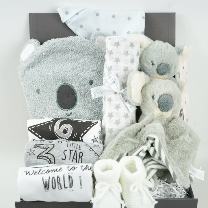 koala themed baby hamper box with koala grey hooded baby towel, white and grey cotton knot hat, white and grey muslin, Koala soft toy, Koala comforter , 2 x cotton white milestone vests newborn , 3 months and 6 months , white knit booties