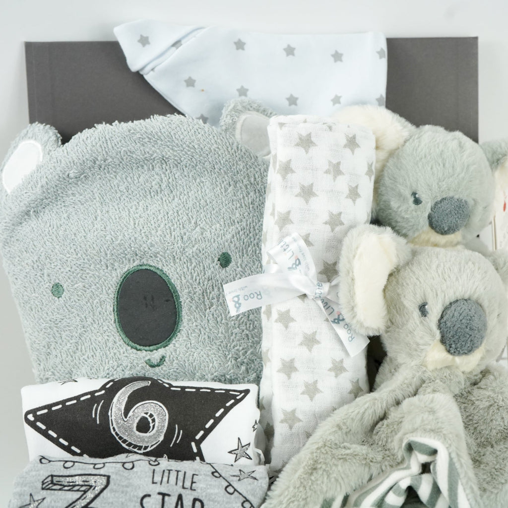 koala themed baby hamper box with koala grey hooded baby towel, white and grey cotton knot hat, white and grey muslin, Koala soft toy, Koala comforter , 2 x cotton white milestone vests newborn , 3 months and 6 months , white knit booties