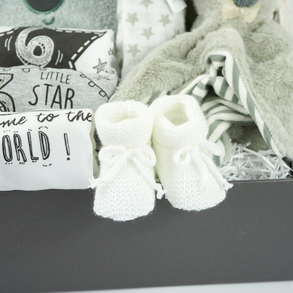 koala themed baby hamper box with koala grey hooded baby towel, white and grey cotton knot hat, white and grey muslin, Koala soft toy, Koala comforter , 2 x cotton white milestone vests newborn , 3 months and 6 months , white knit booties