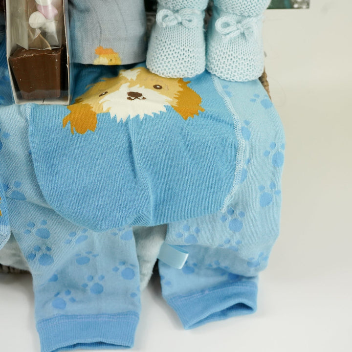 baby boy hamper box with blue puppy baby comforter with taggies, blue legging with a puppy on the bum, blue socks with puppy head, baby blue booties,  blue baby muslin with puppy, blue knot hat with puppy, blue cellular baby blanket, 'The world waited for you ' book