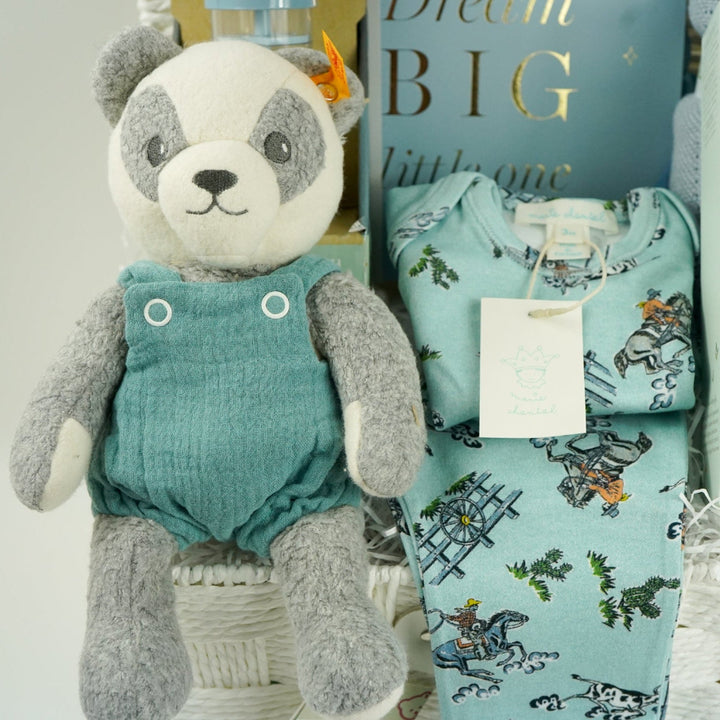 uxury baby boy gift hamper with blue rain rattle, dream big photo album in blue . blue bamboo cellular blanket, luxury GOTs panda soft toy by Steiff, Luxury baby boy pyjamas with cowboys, mum stretch mark cream