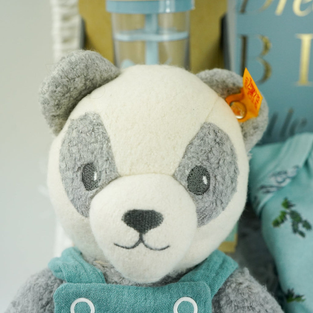 uxury baby boy gift hamper with blue rain rattle, dream big photo album in blue . blue bamboo cellular blanket, luxury GOTs panda soft toy by Steiff, Luxury baby boy pyjamas with cowboys, mum stretch mark cream