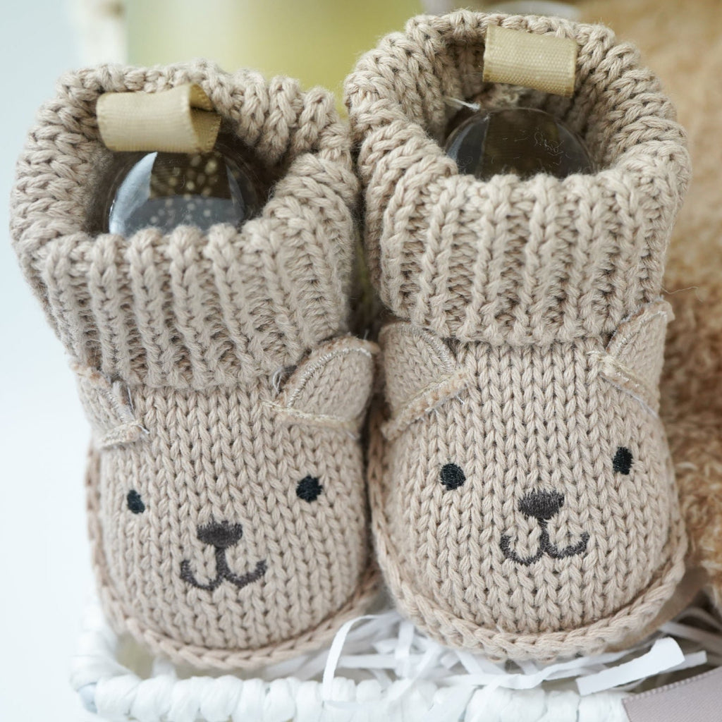 teddy themed baby gift hamper, neutral cream baby cardigan with embroidered teddy on the back, soft Nattou teddy with matching comforter, caramel coloured baby teddy booties, baby organic wash, no alcohol prosecco