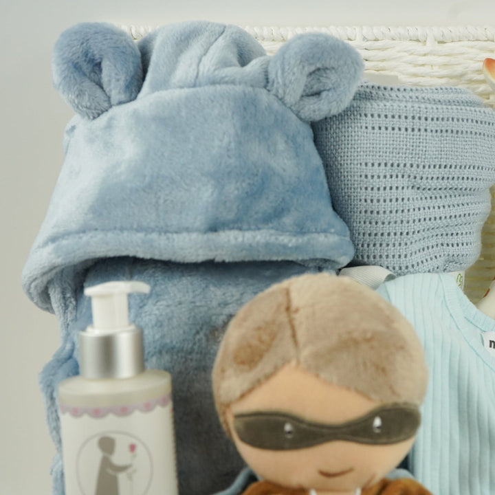 aby gift basket with plush toy, clothing, and baby products including sleepsuit, toiletries, Sophie la giraffe, botties , baby dressing gown in dusty blue