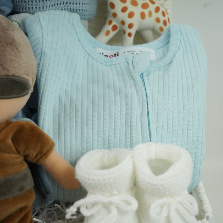 aby gift basket with plush toy, clothing, and baby products including sleepsuit, toiletries, Sophie la giraffe, botties , baby dressing gown in dusty blue
