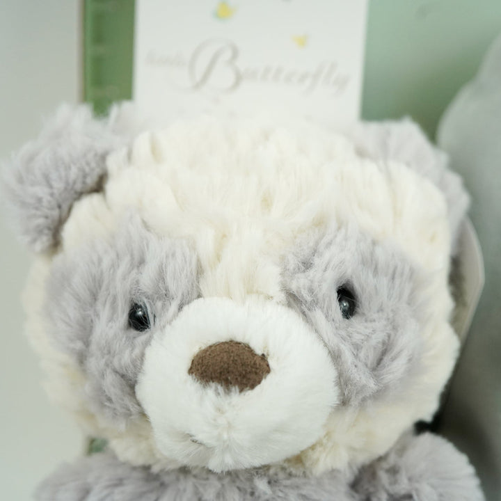 luxury neutral baby hamper in luxury baby keepsake suitcase in pale green with velour angel wings sleepsuit, organic baby toiletries, soft grey alpaca baby slippers and grey and white soft panda toy 