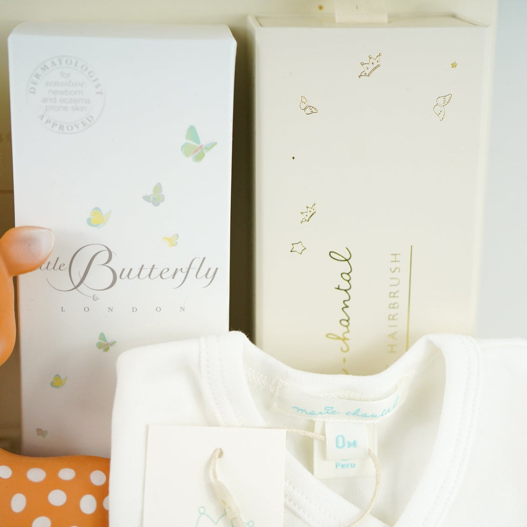 luxury baby gift hamper in cream box with tie, soft mouse cuddly toy, fanfan deer teething toy, organic toiletries , luxury hairbrush in a box, luxury prima cotton baby 2 piece cream clothing set, alpaca slippers 