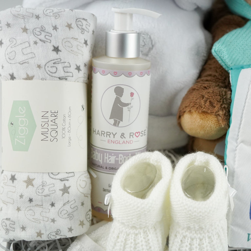 Baby care products including a bottle, socks, and a blanket with 'Harry & Rose' branding.