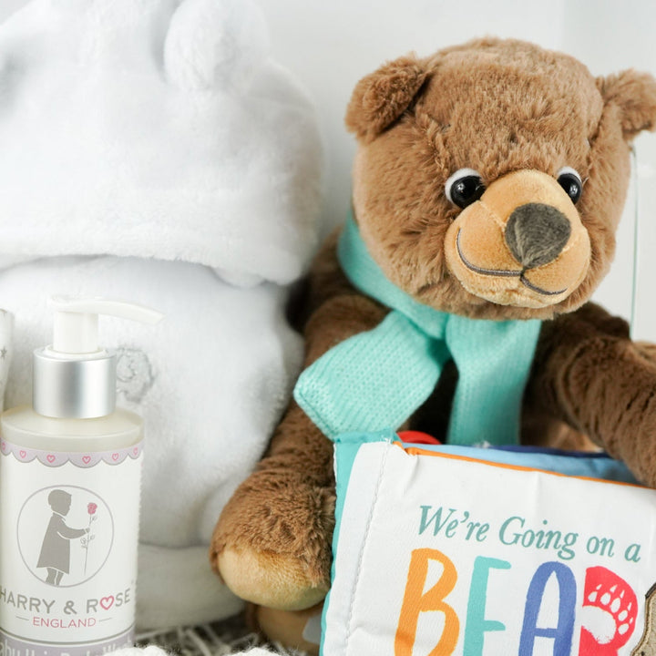 Teddy bear with a book and bottles on a white background