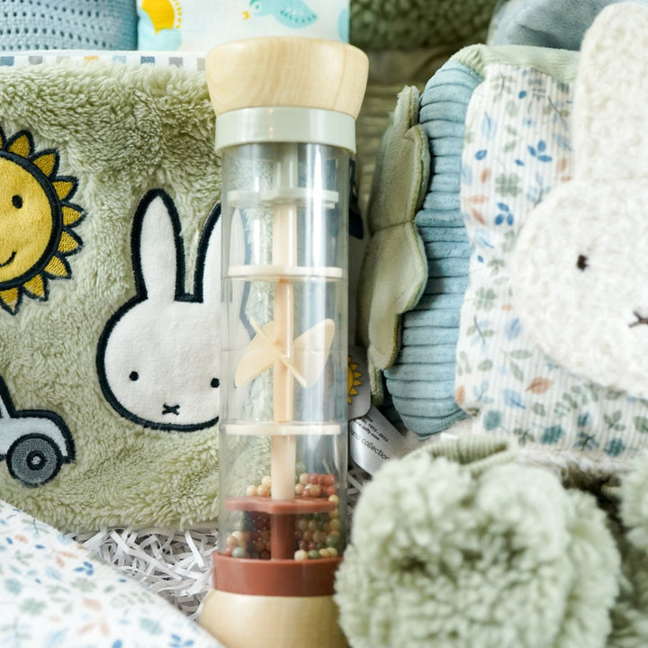 miffy themed baby hamper with green soft book, activity cube in pastel shades of green, white and blue, miffy soft rattle and matching comforter, rain rattle, blue cellular blanket, white muslin swaddle with bluebirds, fluffy green hat with ears and matching booties 