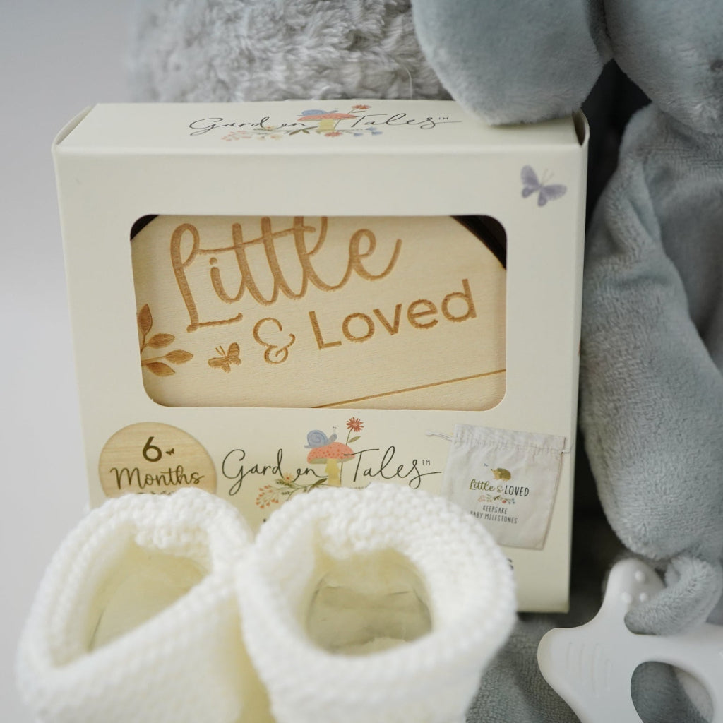 grey elephant hamper with blanket baby comforter, baby dressing gown and soft elephant toy , wooden milestone discs and white booties 