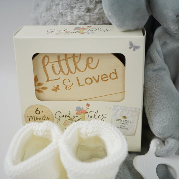 grey elephant hamper with blanket baby comforter, baby dressing gown and soft elephant toy , wooden milestone discs and white booties 