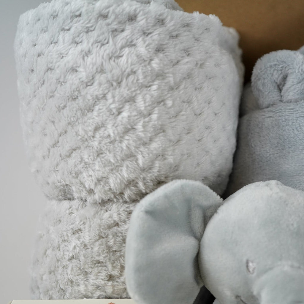grey elephant hamper with blanket baby comforter, baby dressing gown and soft elephant toy , wooden milestone discs and white booties 
