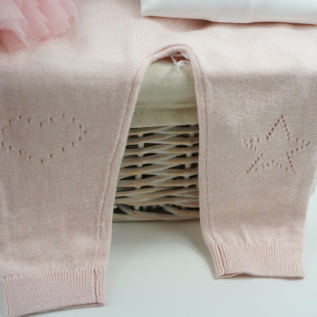 luxury baby girl gift hamper with luxury knitted baby girl outfit in pink, steiff rabbit with pink tutu, luxury hairbrush in a box, box of luxury socks, baby white swaddle with butterflies , luxury candle, white body suit with embroidered collar