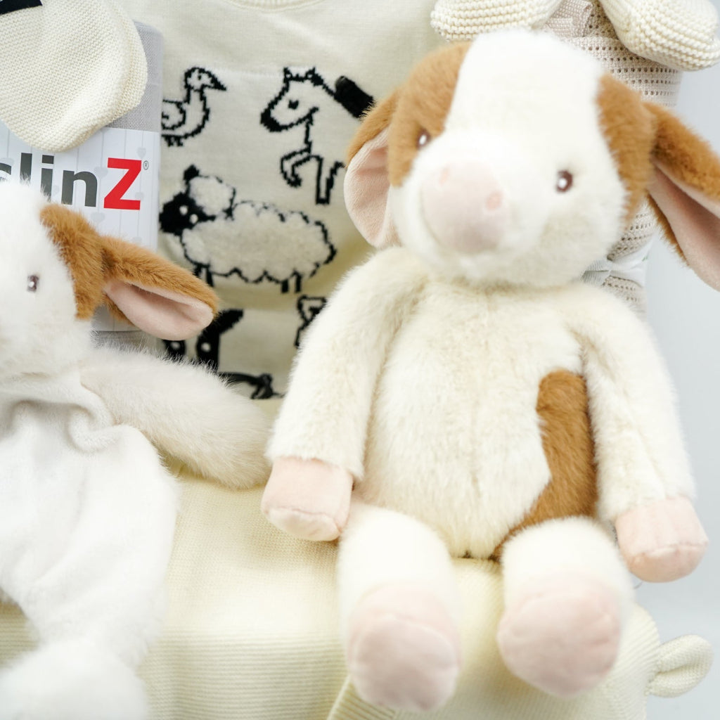 uxury baby gifts in grey hamper basket  organic baby baby clothing set, soft cow and matching rattle and comforter, muslin swaddles, baby organic booties