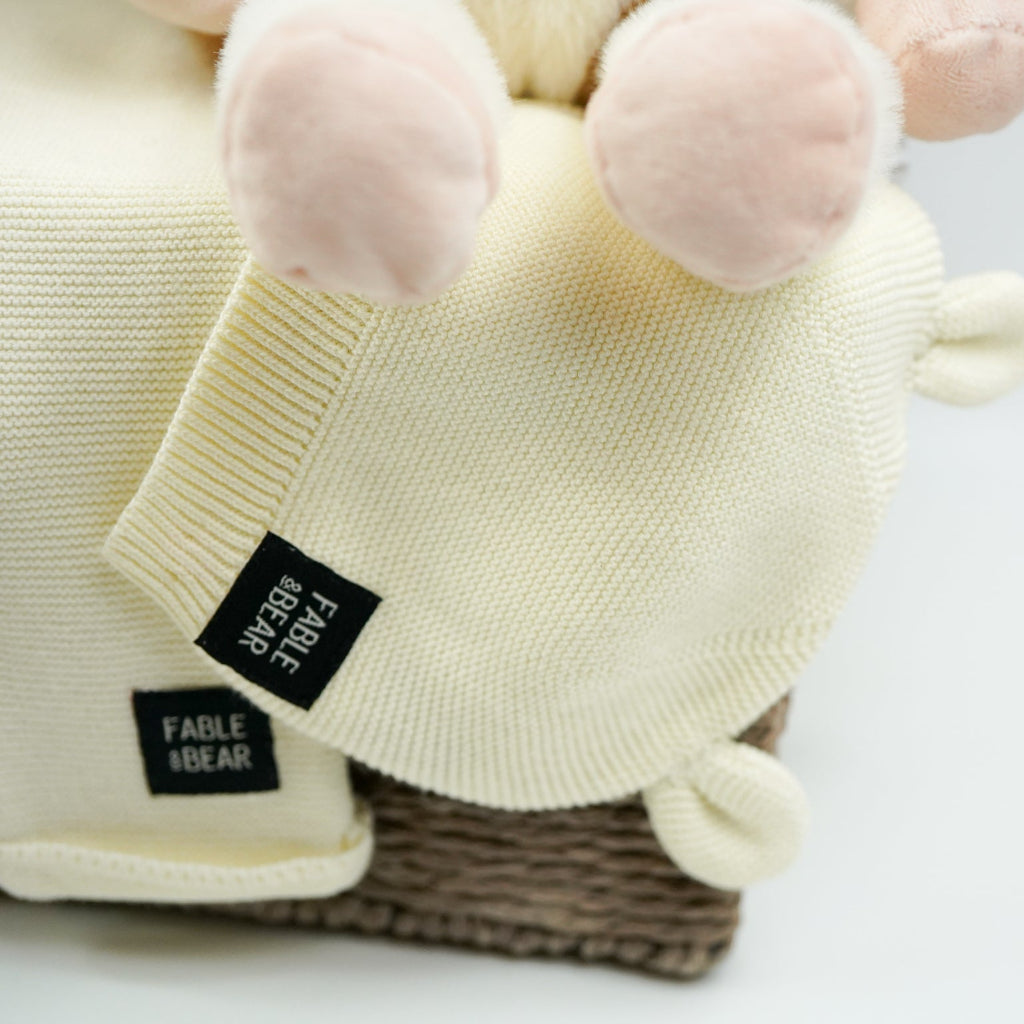 uxury baby gifts in grey hamper basket  organic baby baby clothing set, soft cow and matching rattle and comforter, muslin swaddles, baby organic booties