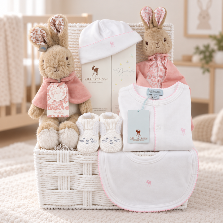Luxury baby girl hamper with luxury white baby sleepsuit, hat and bib trimmed with pink picot edging by G.H.Hurt& son, lopsy bunny comforter and soft toy, bunny booties and luxury hairbush