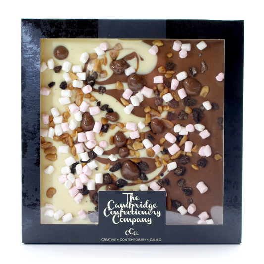 large chocolate slab in white and milk chocolate  with pieces of marsh mallow
