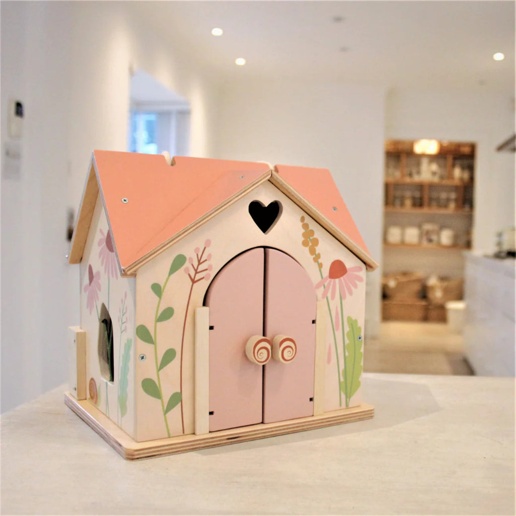 wooden dolls house with pink roof and carry handle, wooden dolls and flowers 