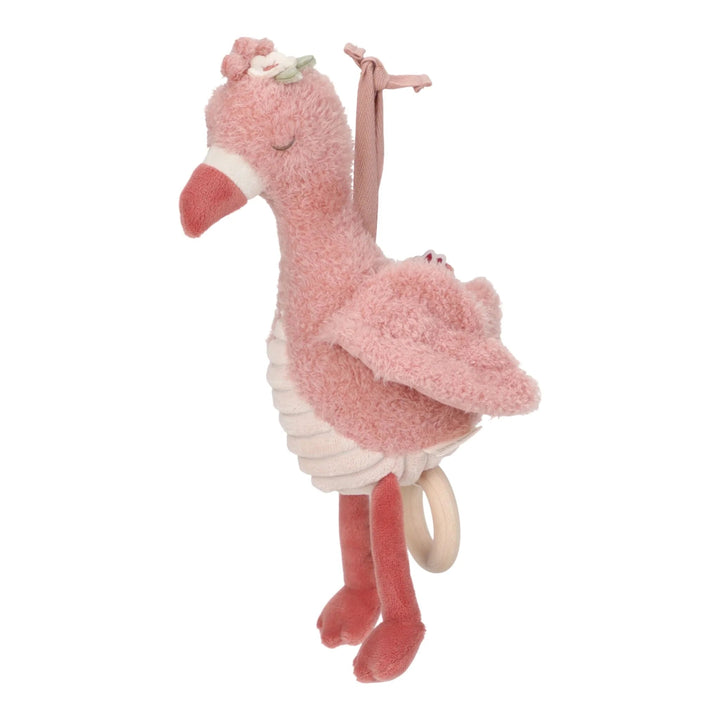 Pink plush flamingo toy with a ring on a white background