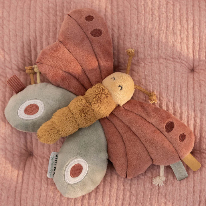 Soft butterfly toy in pink, green and mustard with sensory knots and taggies