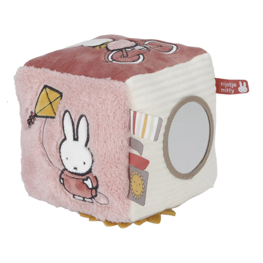 Soft Fluffy Activity Cube Miffy themed in pink with a differebt design on each side, includes a mirror, taggies and pictures of miffy flying a kite and riding a bicycle