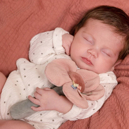 pink soft flower with taggies around the senter on a green stalk with a green leaf baby rattle