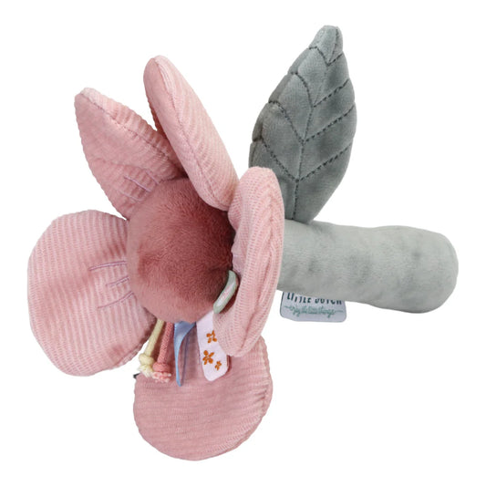pink soft flower with taggies around the senter on a green stalk with a green leaf baby rattle