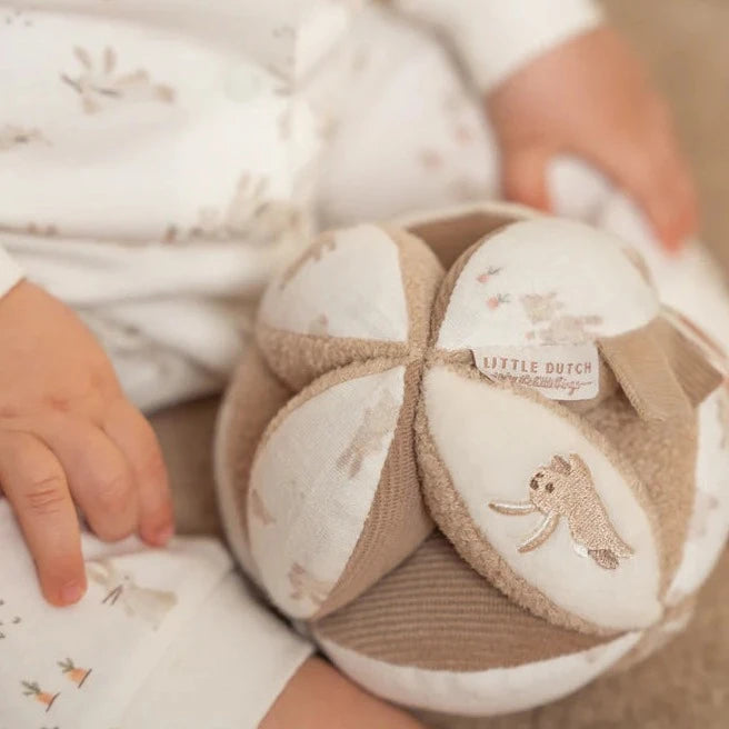 neutral baby sensory ball in soft caramel and white with embroidered bunnies