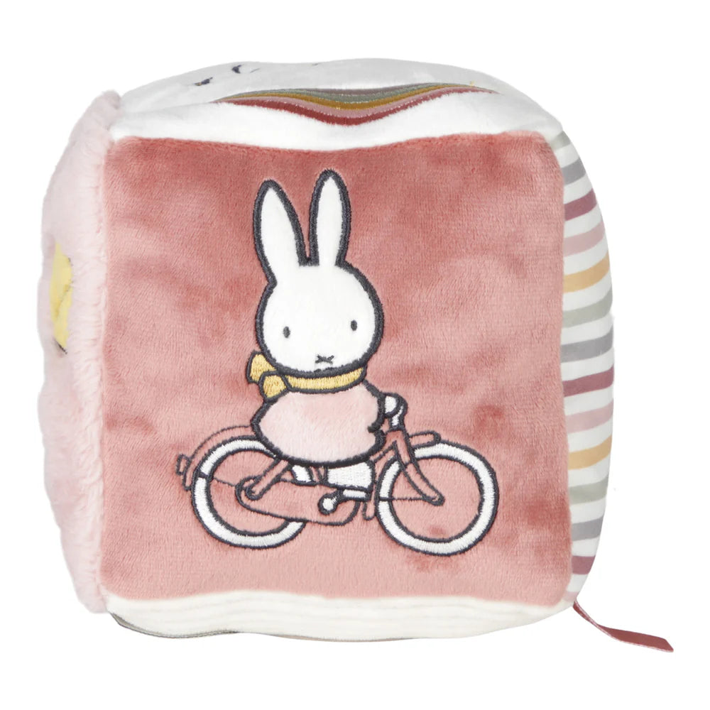 Soft Fluffy Activity Cube Miffy themed in pink with a differebt design on each side, includes a mirror, taggies and pictures of miffy flying a kite and riding a bicycle