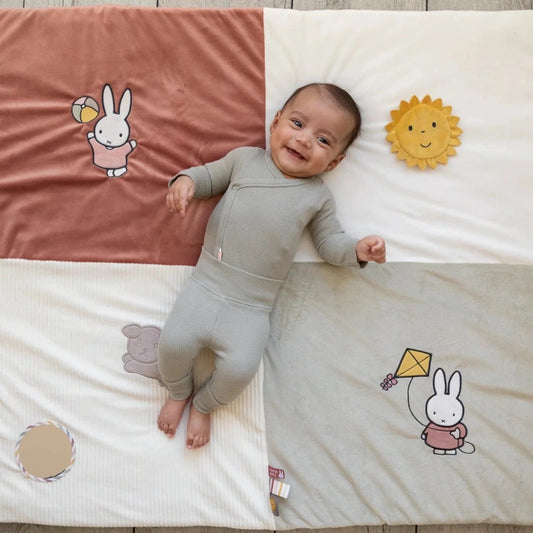 baby girl playmat in 4 quatrers with pictures of miffy, taggies and mirror 