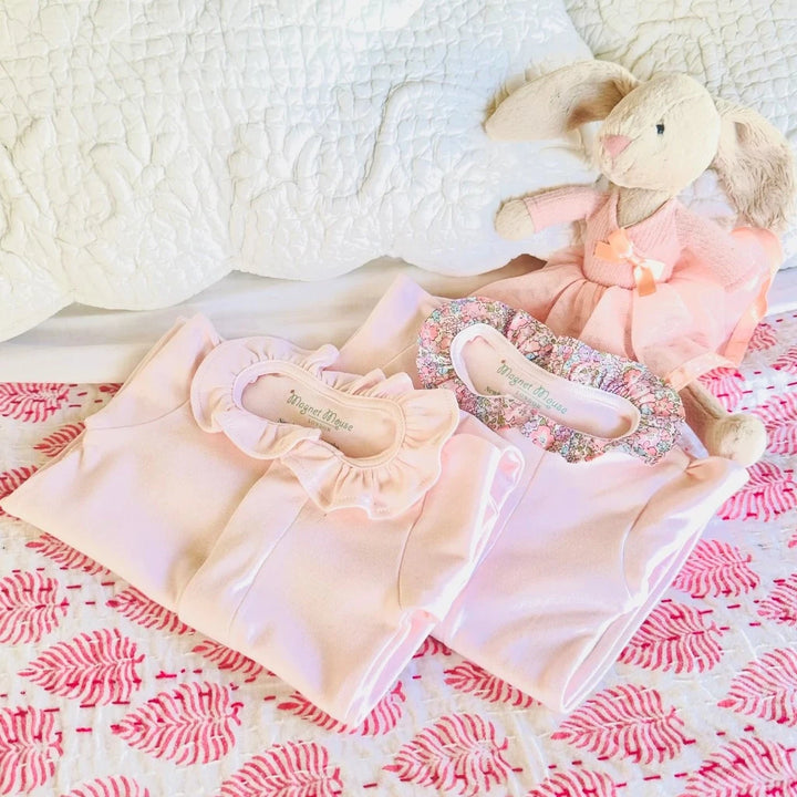 pink magnet fastening baby pink sleepsuit with liberty ruffle fabric