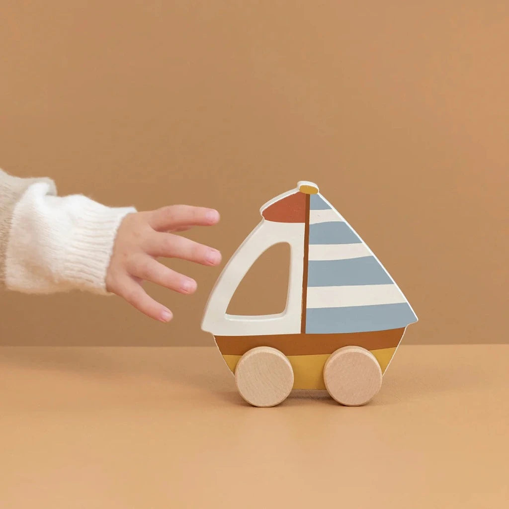 Wooden push along sailboat in blue and white stripes