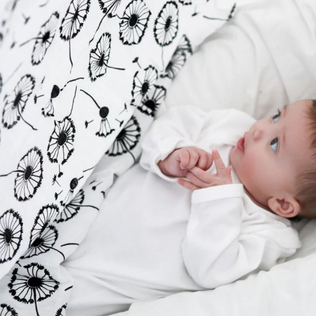 white and black baby sensory muslin with black dandelions 