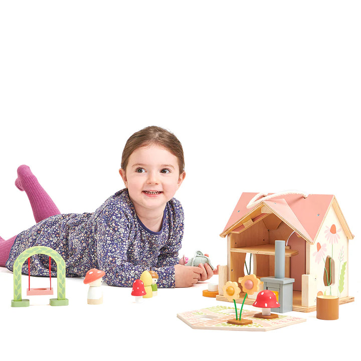 wooden dolls house with pink roof and carry handle, wooden dolls and flowers 