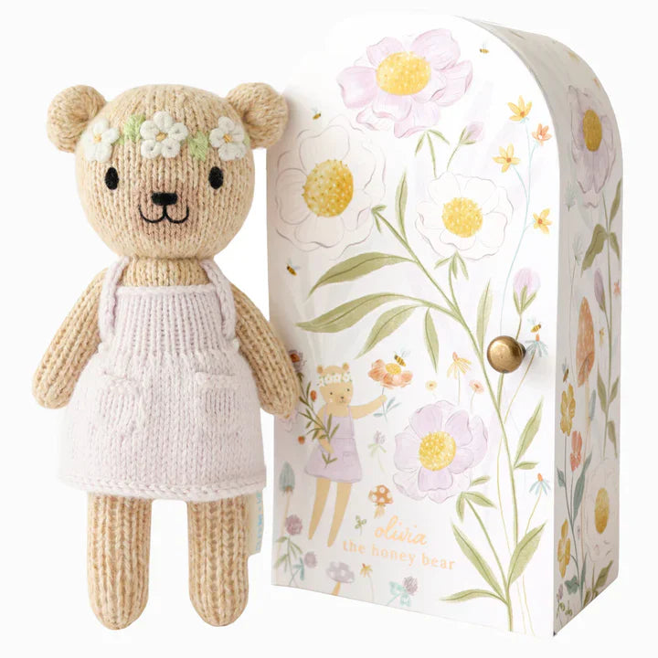 baby and mum to be hamper with luxury pink baby grow, white swaddle with butterflies, pink fluffy double pom pom hat, luxury bump candle, deep pink bamboo cellular blanket, Cuddle & Kin Artisan knitted teddy with own house, pink baby booties with a bow