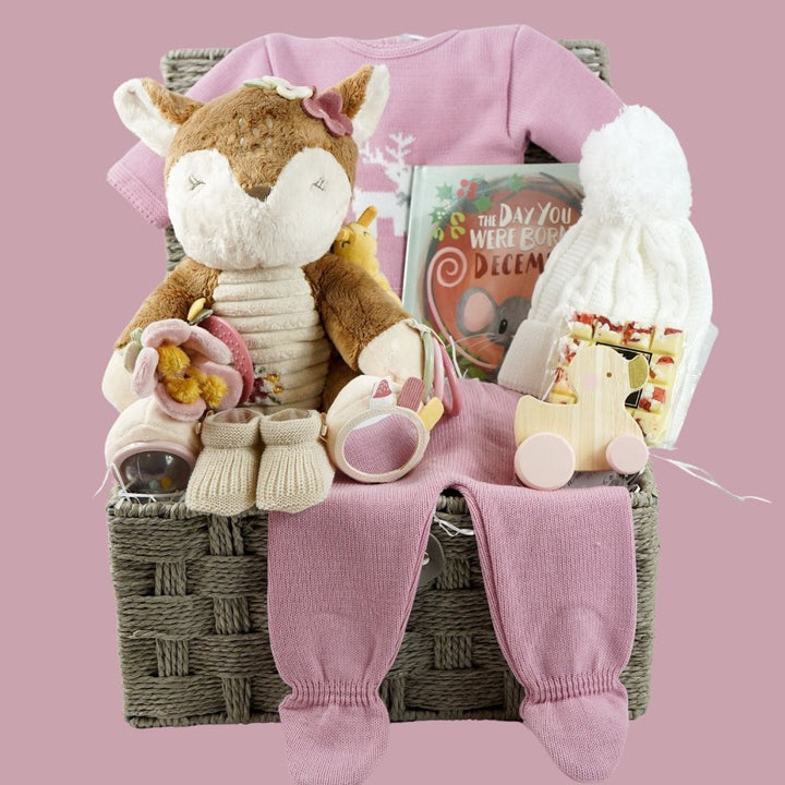 baby girl christmas hamper, Little Dutch soft activity deer, December baby book, baby pink knit Christmas outfit with white reindeer, wooden push along duck, Eaton mess chocolate bar, knit pom pom hat