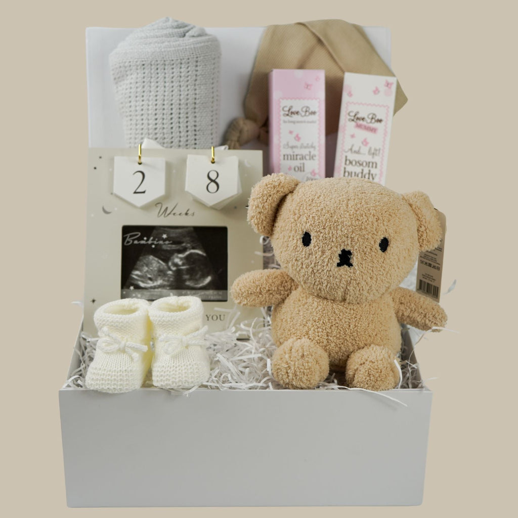 pregnancy hamper box, grey cellular baby blanket, biscuit coloured knot baby hat, antenatal toiletries, soft miffy teddy in biscuit, white knit booties, scan picture frame with pregnancy wooden countdown discs