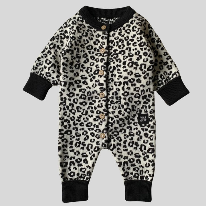 organic baby hamper with cream and black leopard prink knitted romper and  cardigan and matching hat in organic cotton, organic cotton cream blanket, organic steiff teddy, organic toiletries , organic black and white muslins and wooden sutainable hairbrush