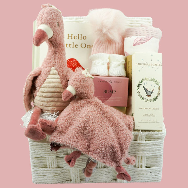 Baby gift basket with plush flamingo toys and baby items and luxurt new mum candle