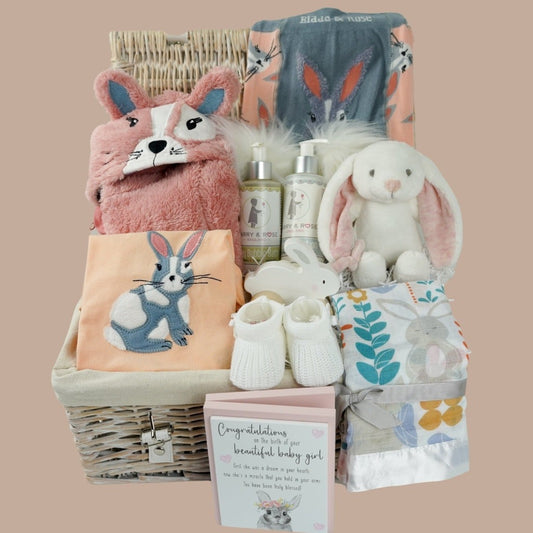 Baby girl rabbit themed hamper, Blade and rose baby girl clothing set in peach colour with applique rabbit on the top and rabbit on the leggings bum, fleece jacket with rabbit hood and ears in peach, baby organic toiletries, soft rabbit toy, wooden forever congratulations card, baby swaddle with rabbit and owl design