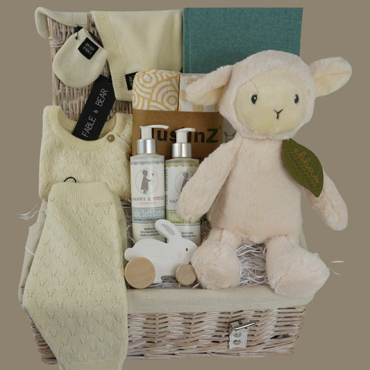 organic baby hamper gift, organic pointelle design baby outfit in cream includes cross over jumper, leggings, mittens and cute hat with ears, 2 muslin organic swaddles in white with yellow swirl, baby journal, organic bubble bath and bay lotion, wooden push along toy, organic soft rabbit toy