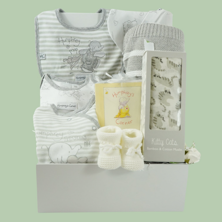 neutral baby hamper in a white gift box, includes an grey and white Humphreys corner baby clothing set and booklet, grey and white cotton blanket, grey and white bamboo and cotton swaddle and white knit baby booties