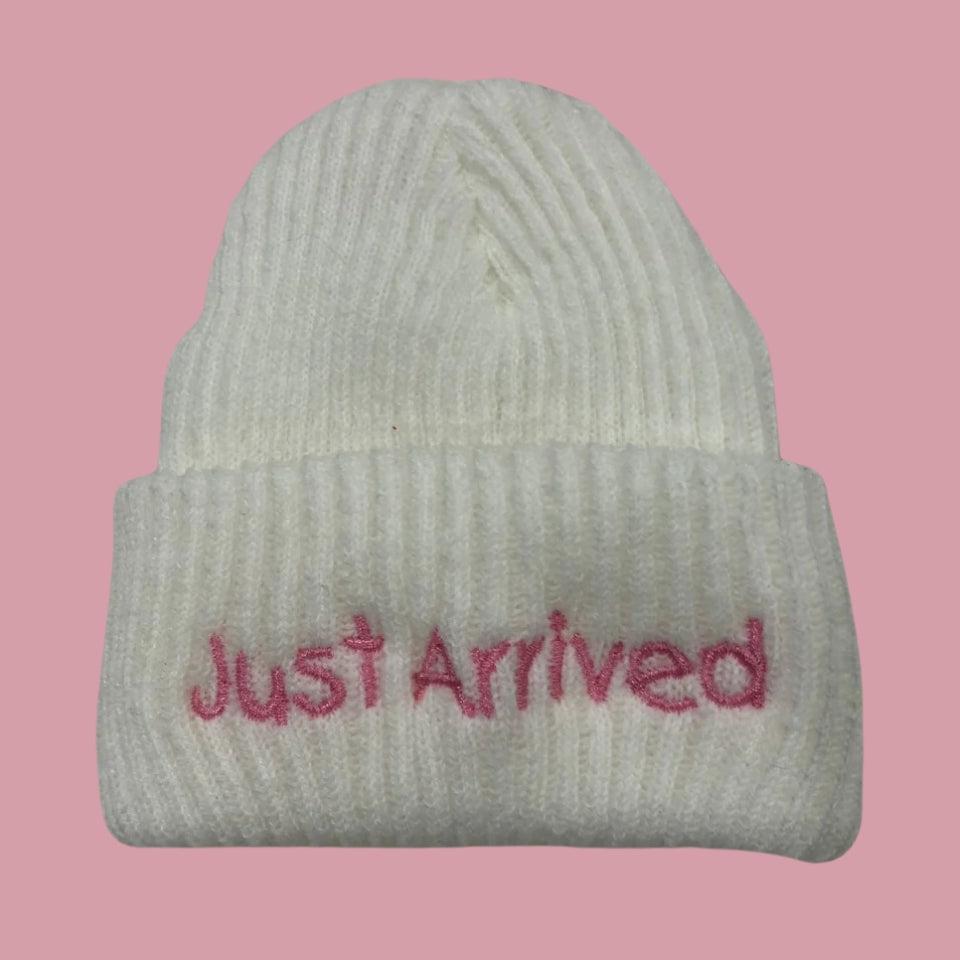 white announcement newborn beanie hat with pink embroidered 'just arrived'