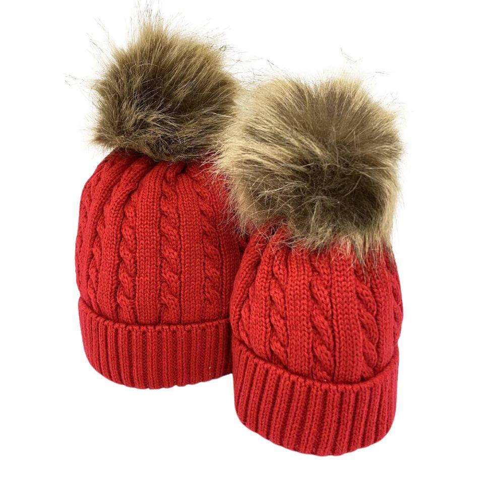 mum and child matching red hat with faux fur pompom